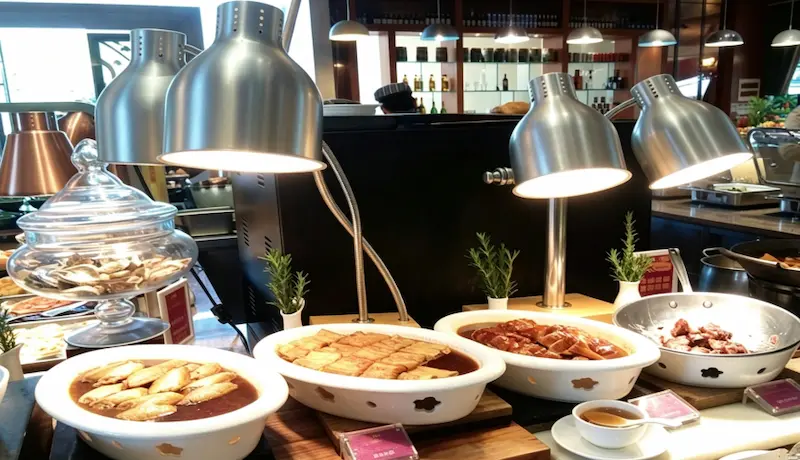 food warmer heat lamp on buffet counter in commercial foodservice.webp